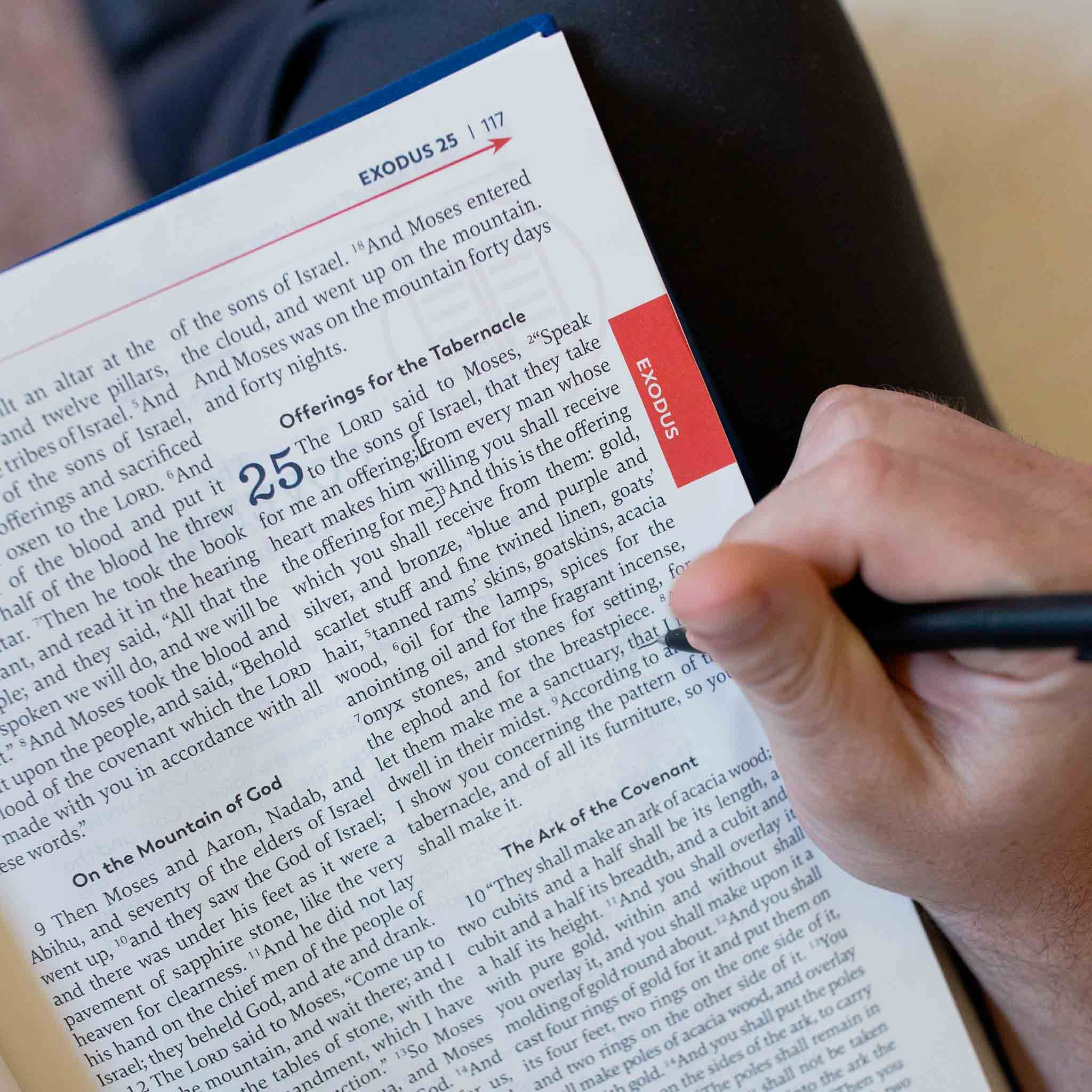 A reader of the Great Adventure Catholic Bible making notes in the book of Exodus. This time period is called the Patriarchs, and it's printed in red.